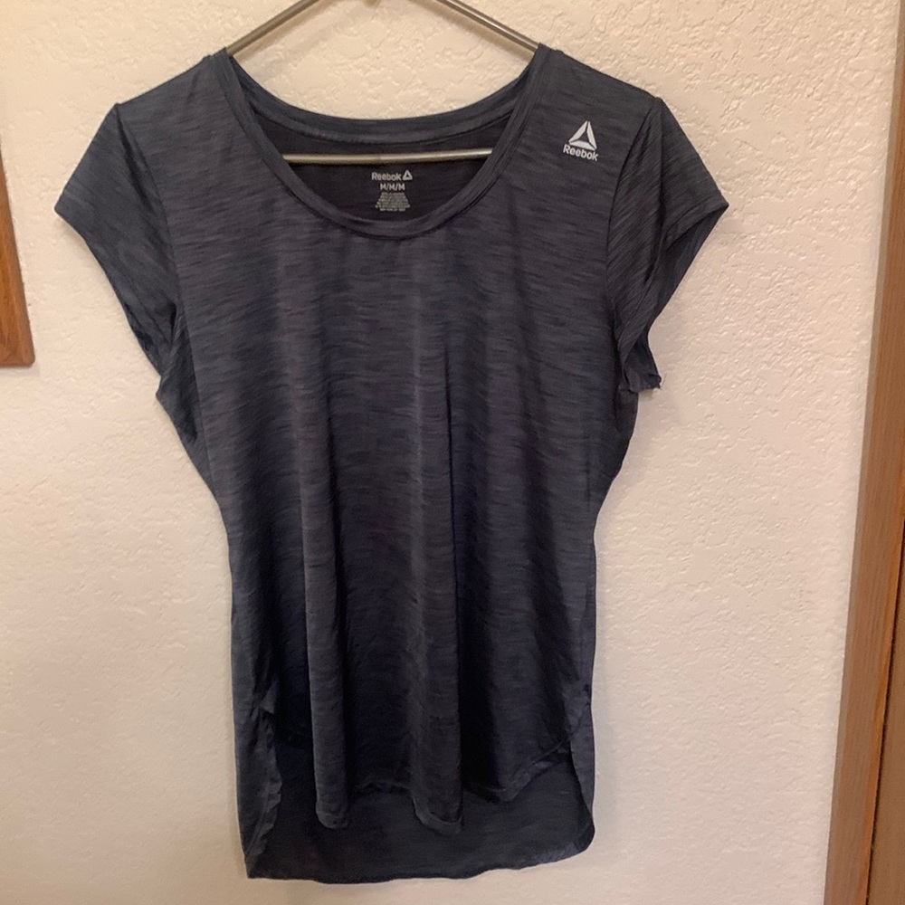 Reebok workout t shirt with reflectors on the front shoulder and middle back.